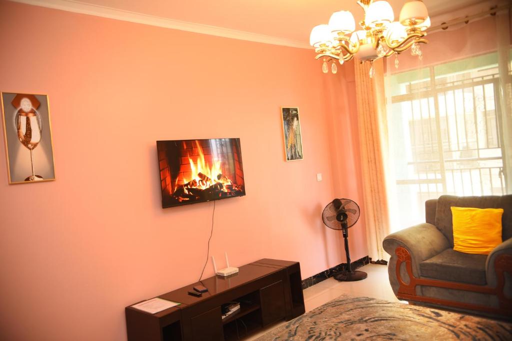 a living room with a fire on the wall at Beauty Homes Kilimani in Nairobi