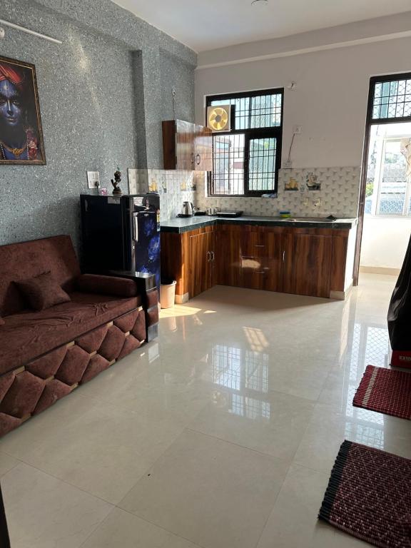 a living room with a couch and a counter at Lalita Kunj - Fully furnished Appartment Vrindavan in Vrindāvan