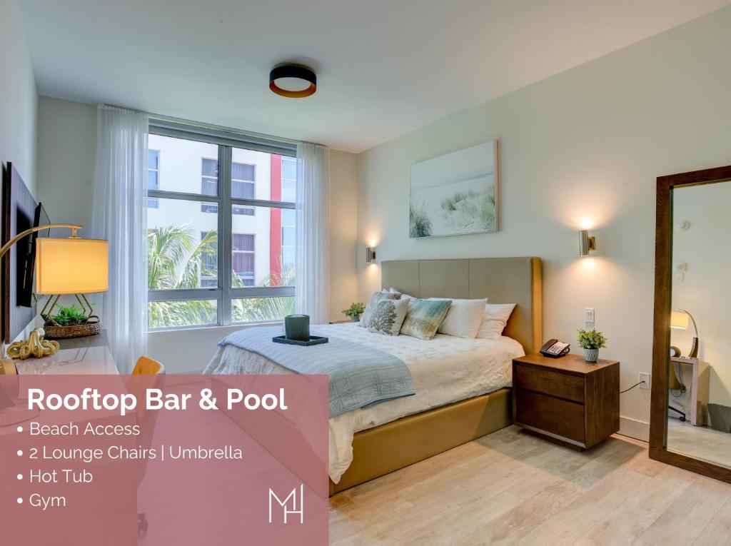 a bedroom with a bed and a large window at New! Beach Access with Rooftop Pool in Hollywood