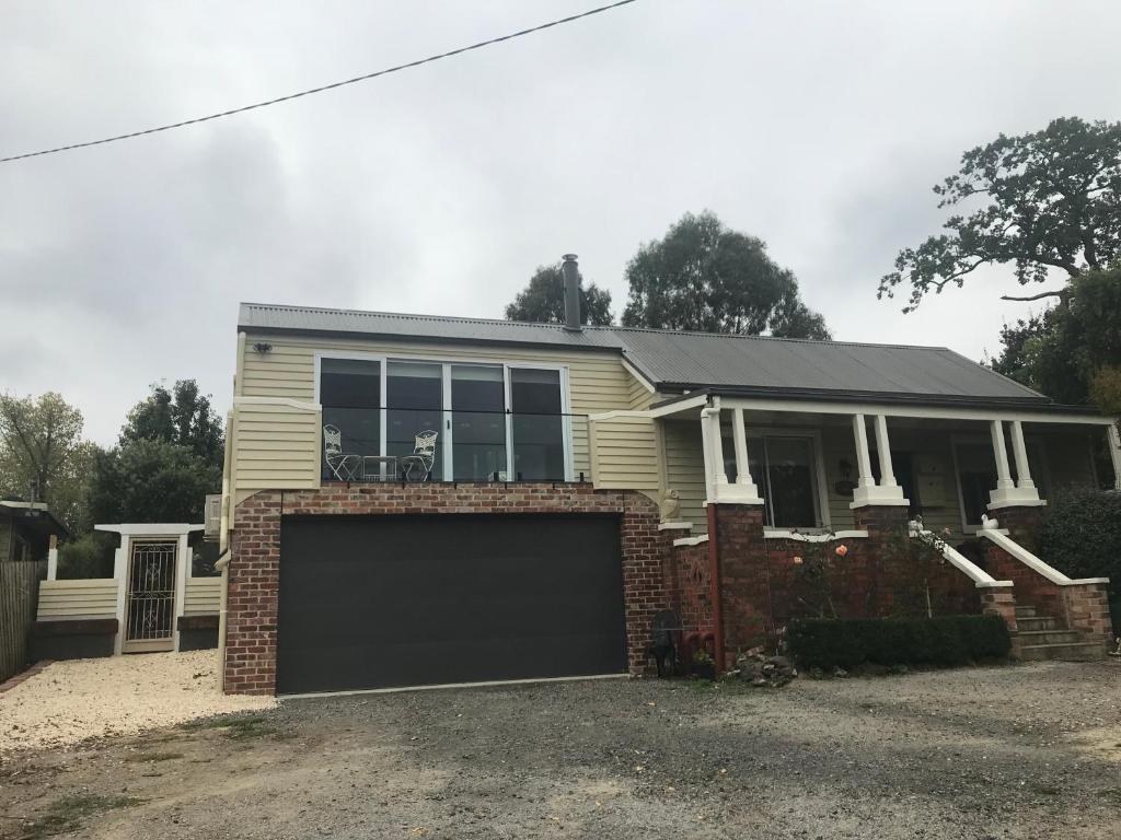 a house with a large garage in front of it at The Yarra Valley Couple Escape in Yarra Glen