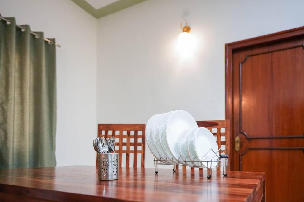 a wooden table with utensils on top of it at Tourist Friendly Home -3BHK AC Near Birla Mandir, Hyderabad in Hyderabad