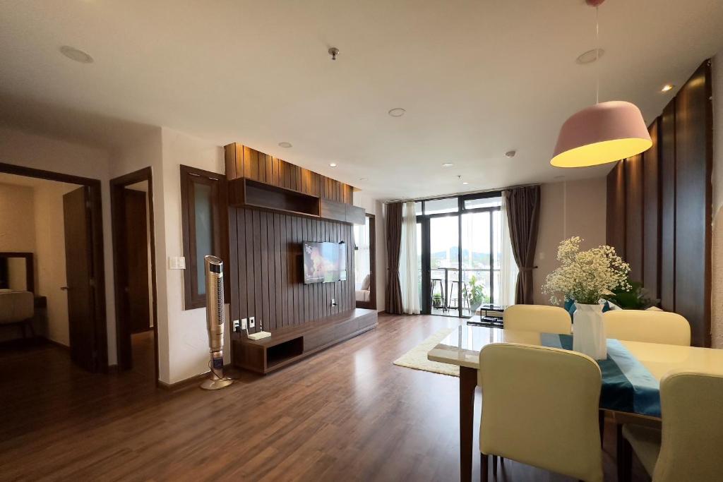 a living room with a dining table and a television at Condo 3 Bedrooms Mountain view in Dalat Center Residence in Da Lat