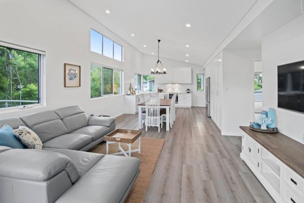 a living room with a couch and a kitchen at Willy Wagtail @ Cape Villas in Dunsborough