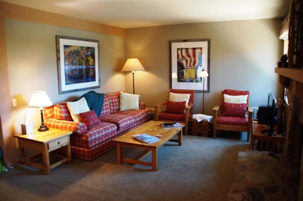 a living room with a couch and two chairs at #278 Ski-in, Ski-out Corner unit with View in Mammoth Lakes