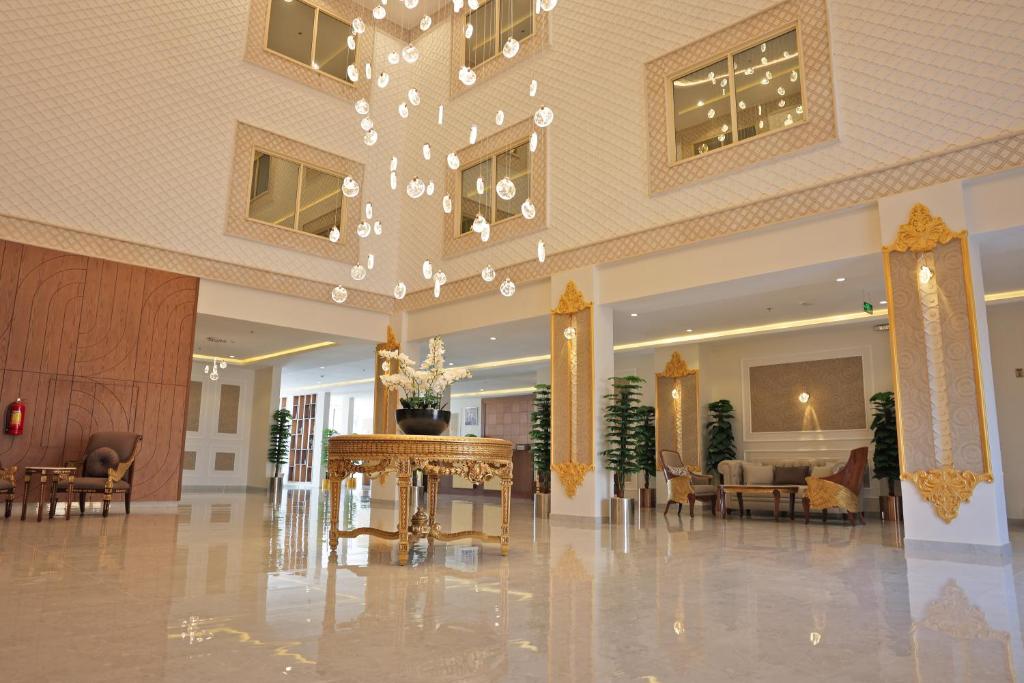 a lobby with a table and chairs in a building at فندق الزوين - Alzuwain Hotel in Arar