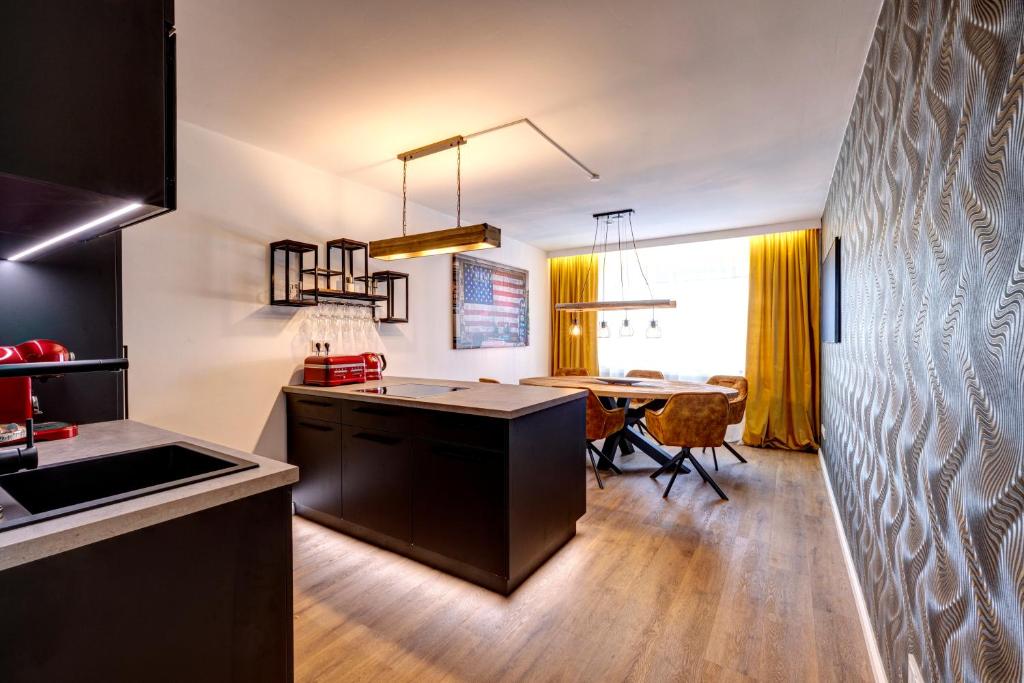 a kitchen with a table and a dining room at Vendum Living in Essen