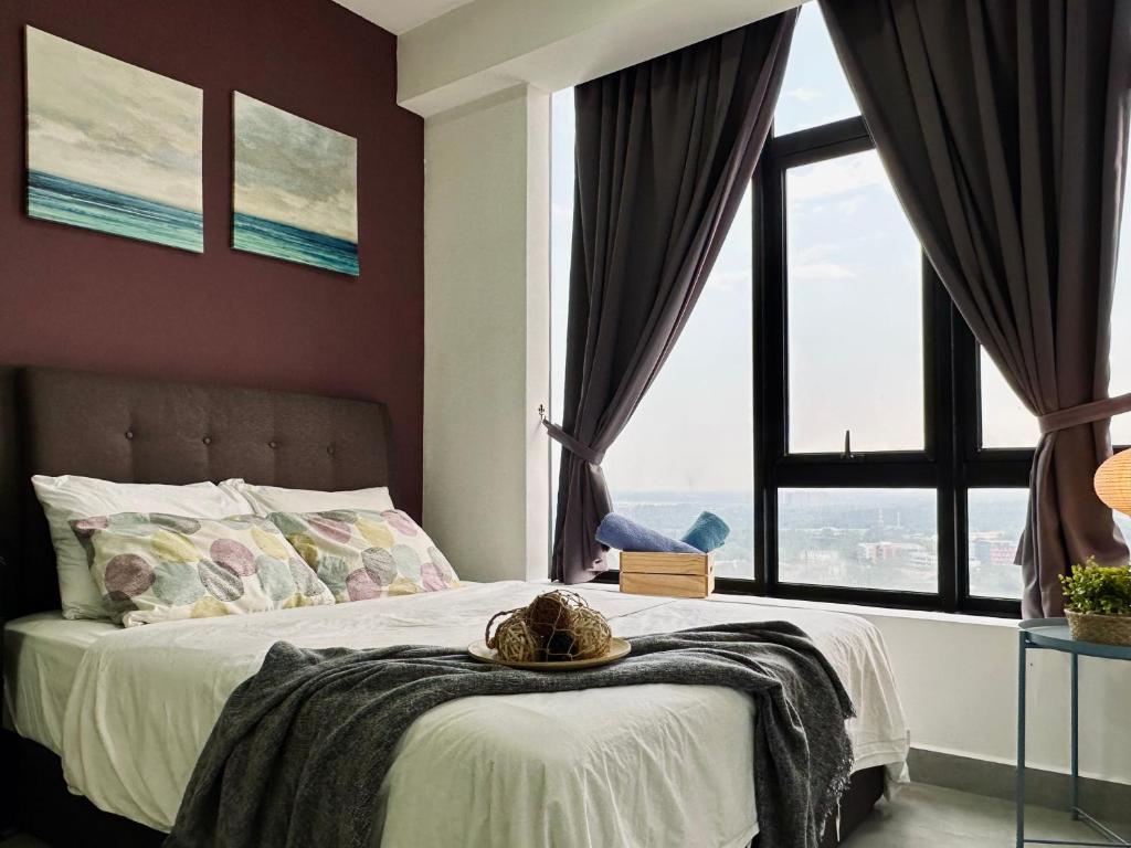 a bedroom with a bed with a large window at Eco Kanvas Soho Suites in Cyberjaya