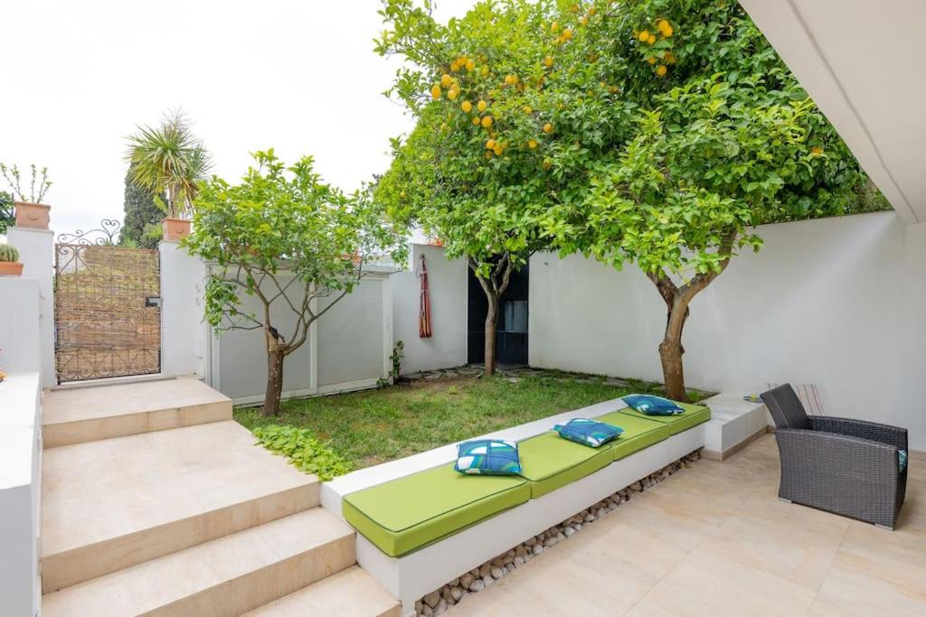 a patio with a table and some trees and stairs at Lemon House, Capri in Capri