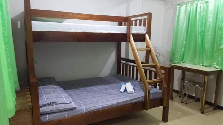 a bunk bed with shoes on the bottom bunk at Al Shamsa Homes in El Nido