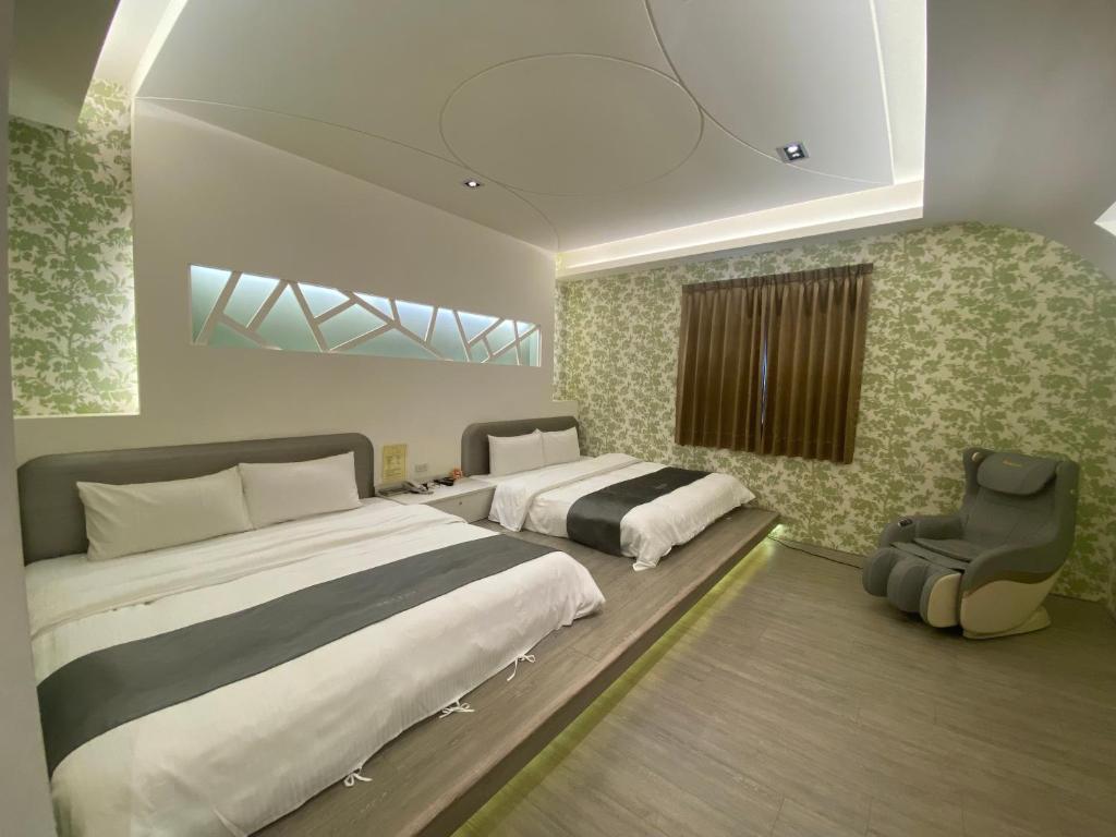 Yuan Chyau Motel tesisinde bir odada yatak veya yataklar