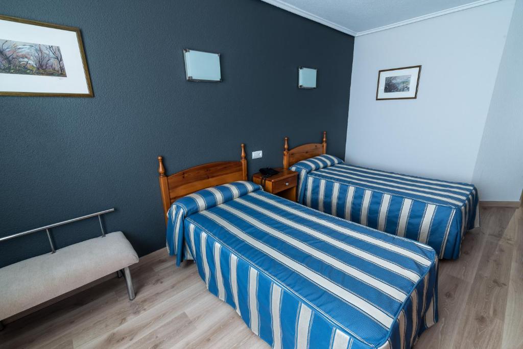 Postel nebo postele na pokoji v ubytování Hotel San Glorio