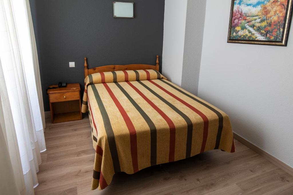 Postel nebo postele na pokoji v ubytování Hotel San Glorio