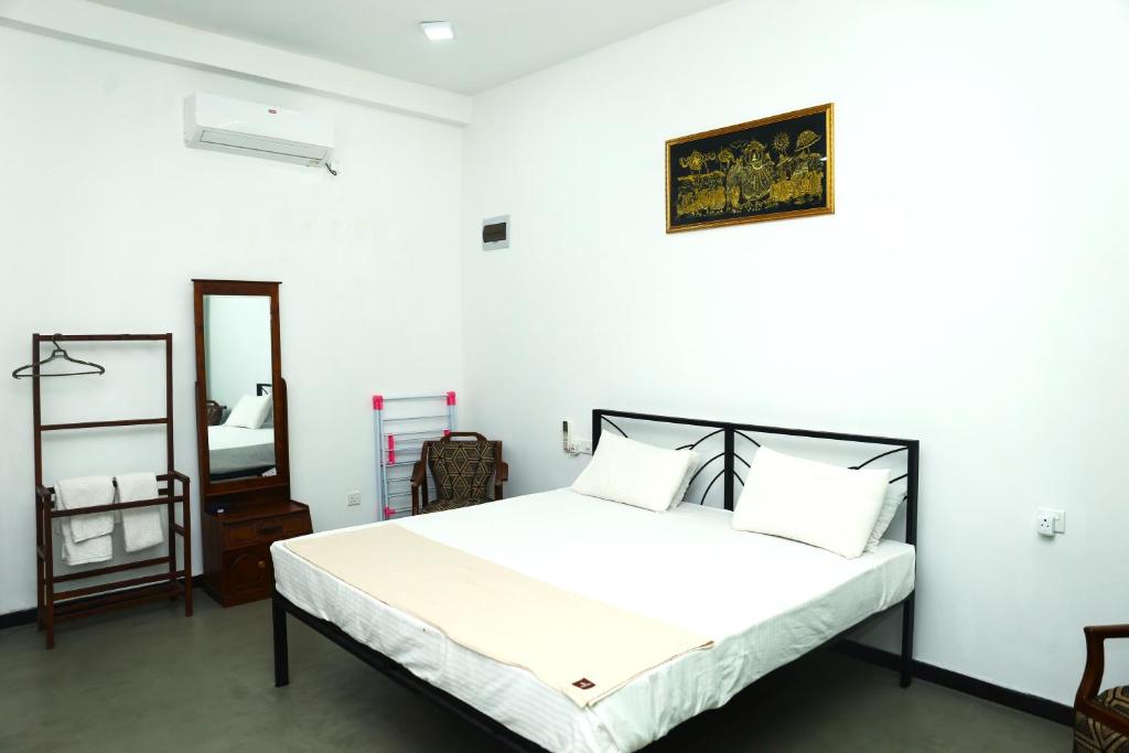 Postel nebo postele na pokoji v ubytování Sandy Palms Guesthouse