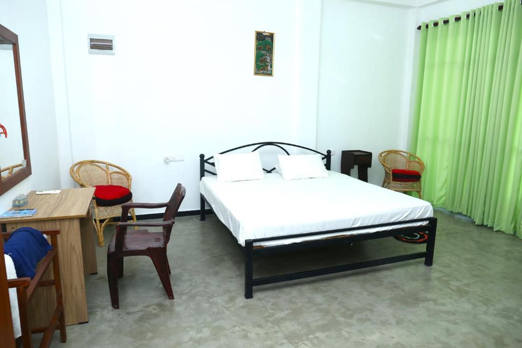 Postel nebo postele na pokoji v ubytování Sandy Palms Guesthouse
