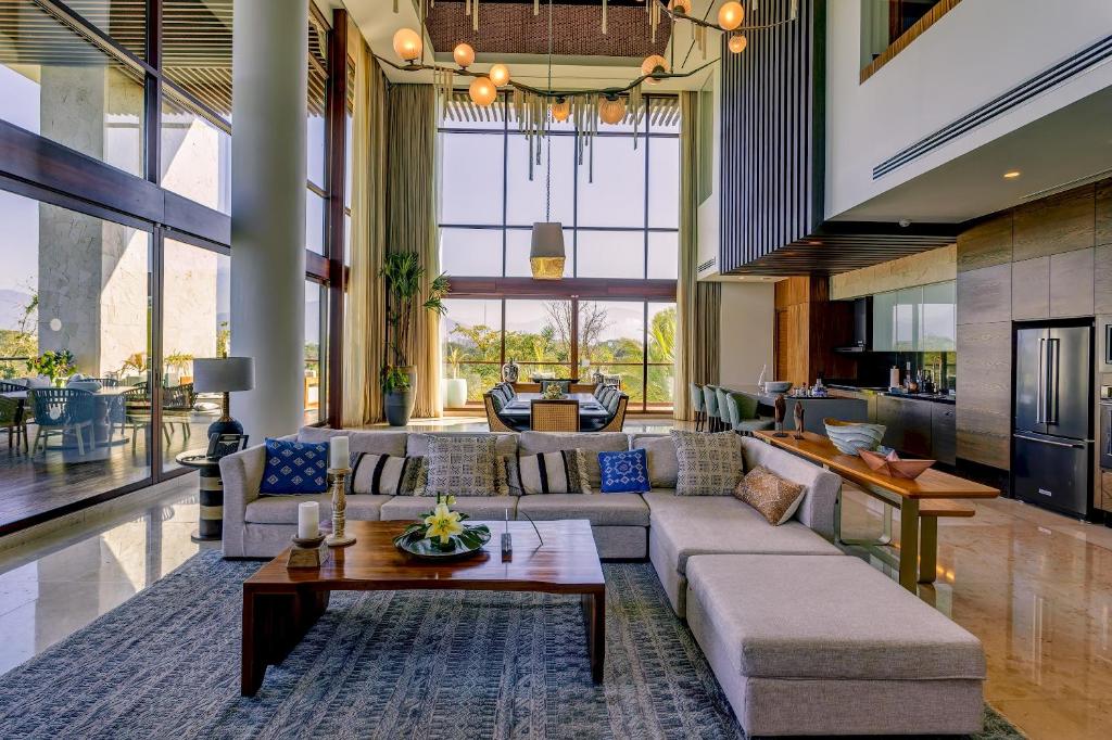 a living room with a couch and a table at The Estates Four Bedroom Loft E1- Nuevo Vallarta in Mesas de Picachos