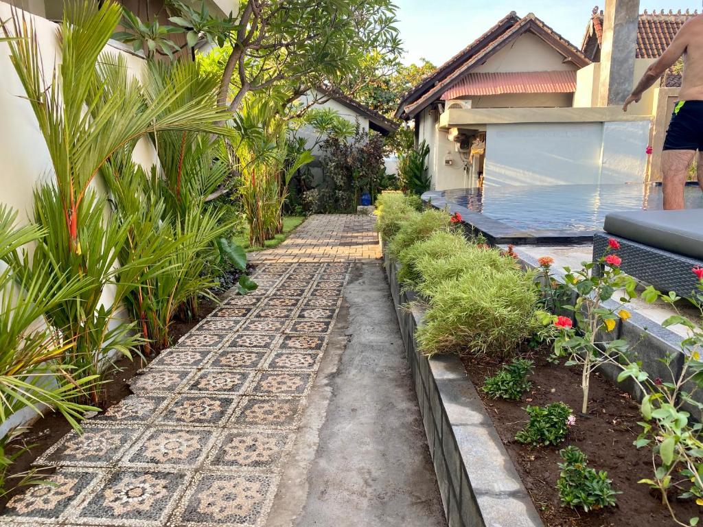 a garden path leading to a house at Solaluna Beach Homestay in Amed