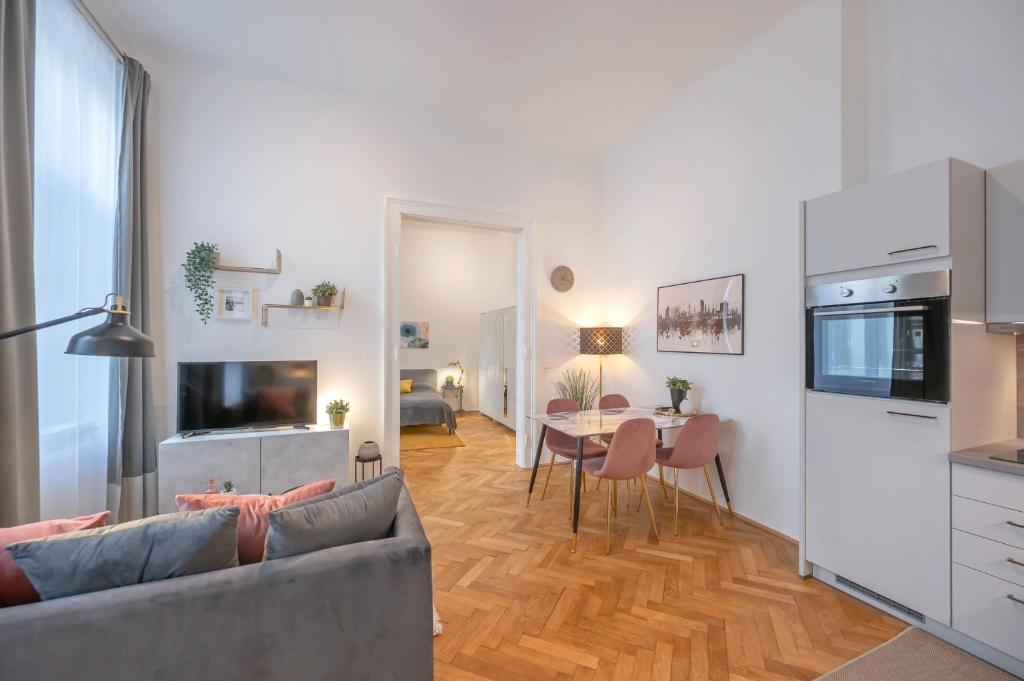 a living room with a couch and a table at Cosy City Center Apartment in Vienna