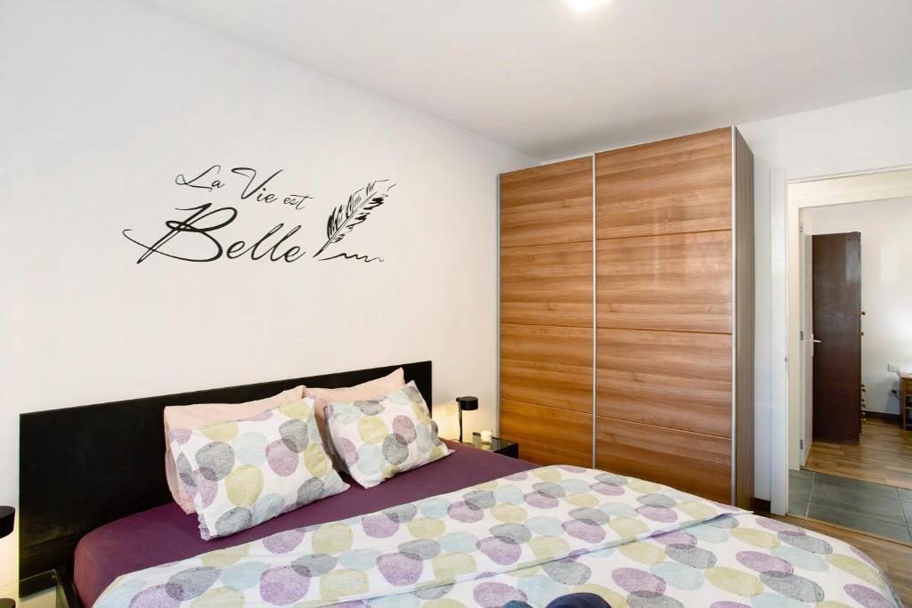 a bedroom with a bed and a wooden cabinet at San Fernando Apartment in San Bartolomé