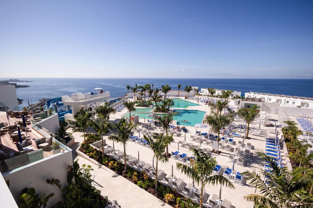 an aerial view of a resort with a pool and the ocean at Servatur Puerto Azul in Puerto Rico de Gran Canaria