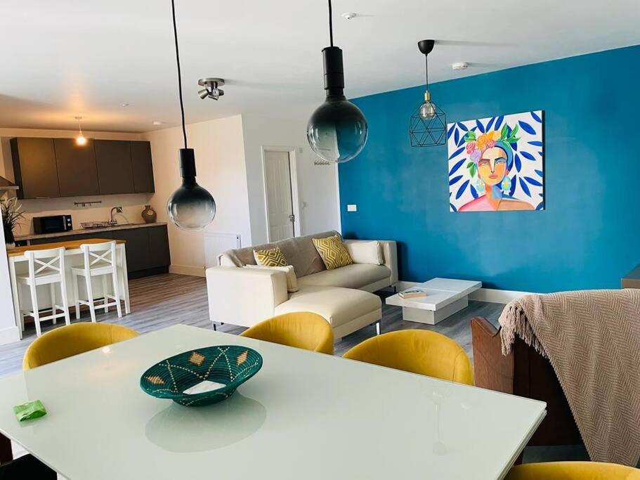 Stunning huge openplan 2Bed flat في ووكينغ: غرفة معيشة مع طاولة بيضاء وأريكة
