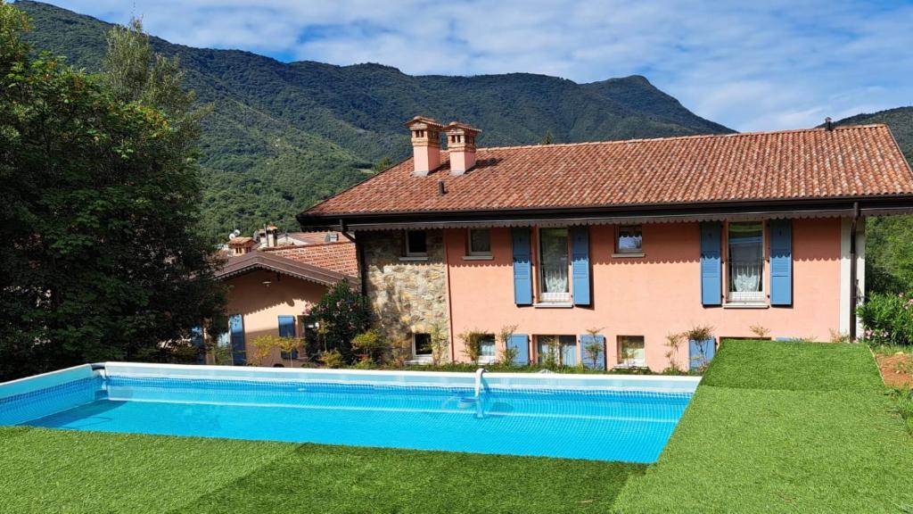 a house with a swimming pool in front of a house at Borgo alla Sorgente in Vallio Terme