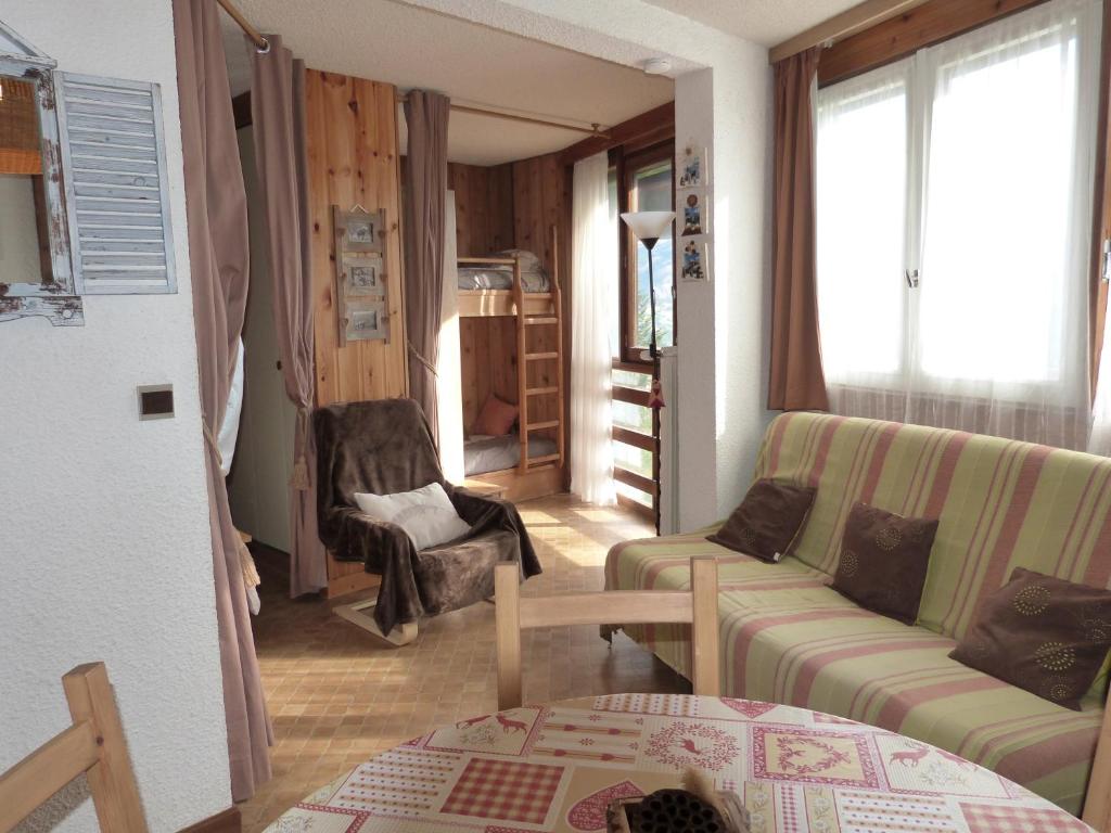 - un salon avec un canapé et une chaise dans l'établissement Studio Alcôve proche des pistes, à Uvernet