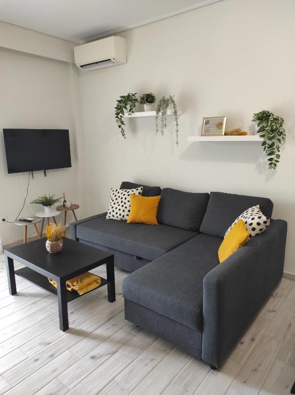 ein Wohnzimmer mit Sofa und Tisch in der Unterkunft Kristy in Artemida