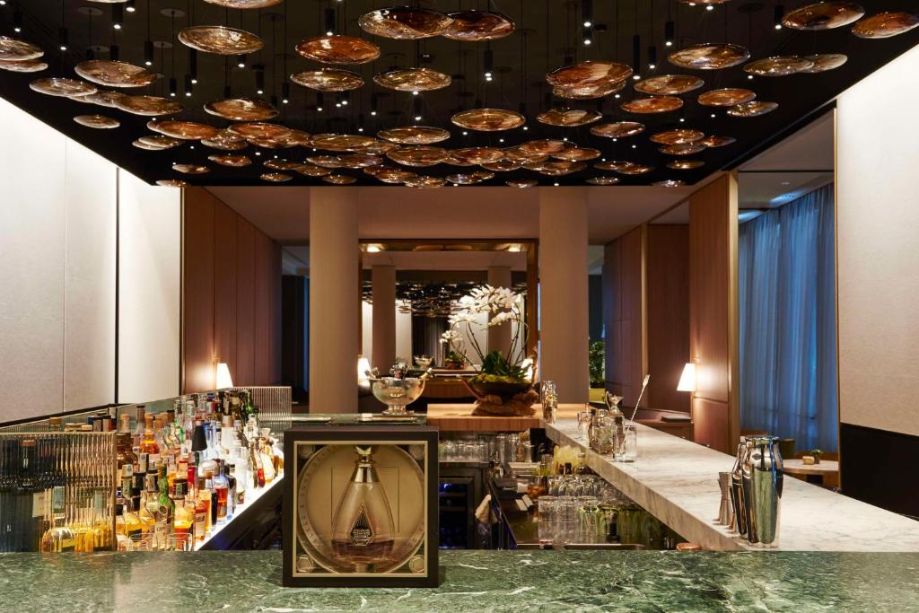 a bar in a hotel with a large ceiling at Park Hyatt Milano in Milan