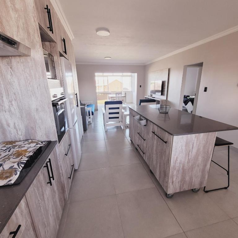 a kitchen with a large island in a room at Blaasoppie 202 in Mossel Bay