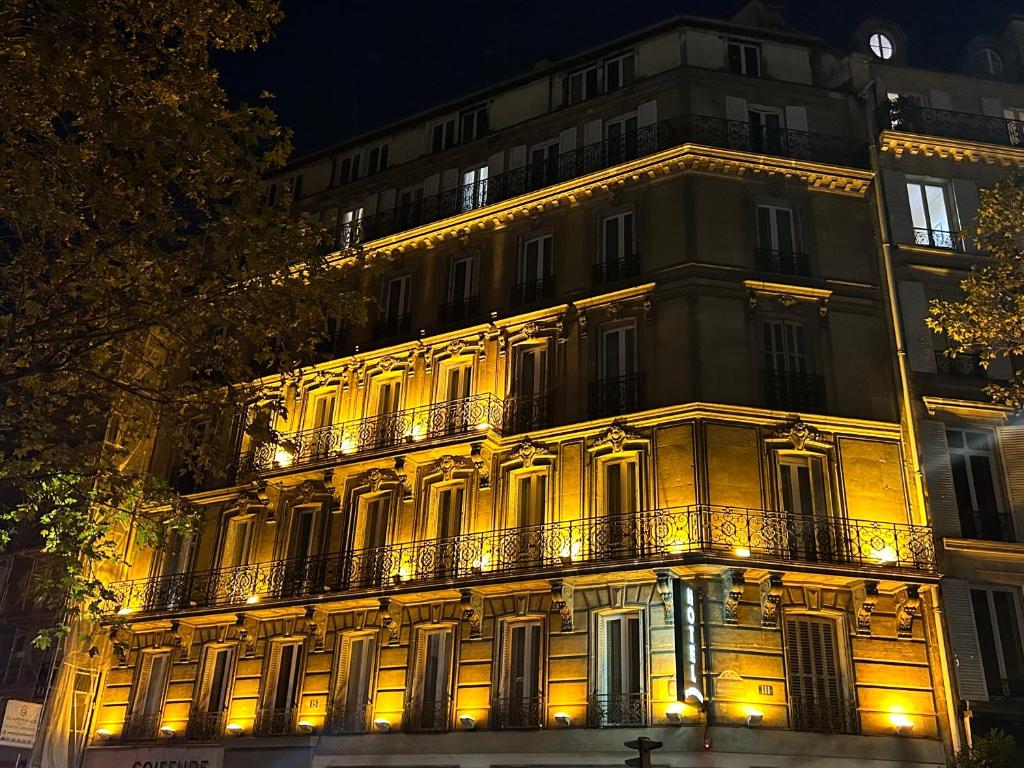 a large building with lights on the side of it at Hôtel d'Argenson in Paris