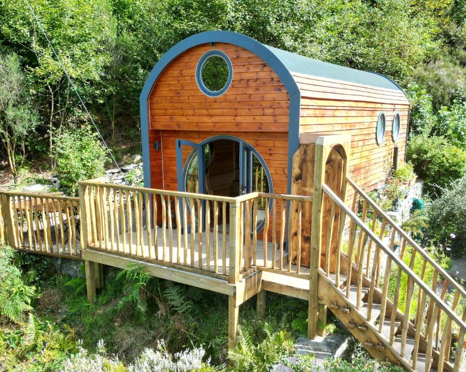 a wooden play house with a ramp and a bridge at The Kites Nest in Ystrad Meurig