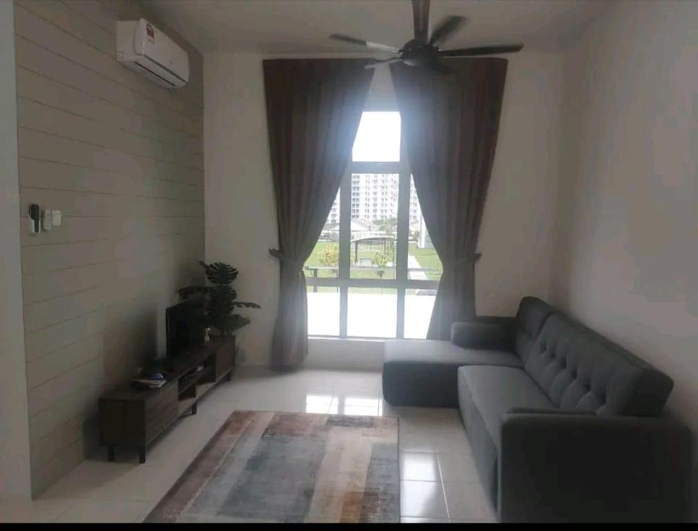 a living room with a couch and a window at 3 Bedroom Apartment with Pool and Beautiful View in Klebang, Ipoh in Chemor