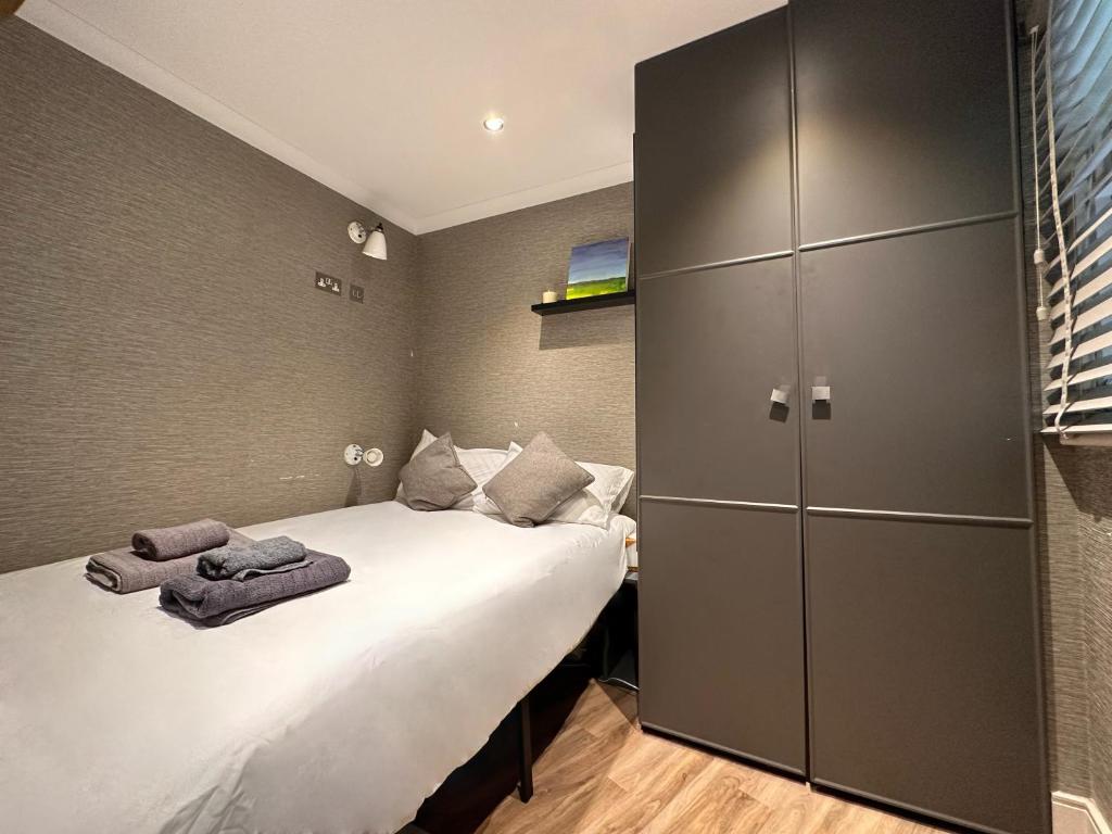a bedroom with two beds with towels on them at Remarkable 1-Bed Studio in London in London