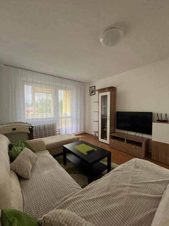 a living room with a couch and a flat screen tv at Apartmán Majka in Snina