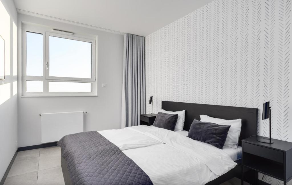 Posteľ alebo postele v izbe v ubytovaní Poznań Apartments Towarowa