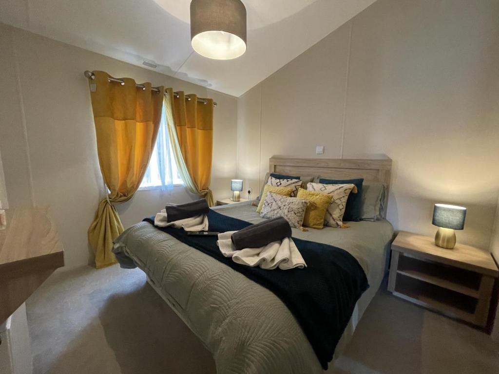 a bedroom with a bed with two towels on it at 2 The Green in Tattershall