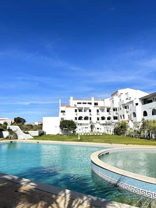 a large swimming pool in front of a building at New Flat surround by beaches. in Sagres