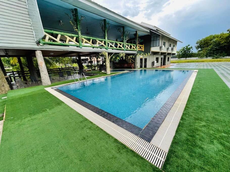 a large swimming pool in front of a building at Lakefront Tree Escape in Buriram, Thailand in Buriram