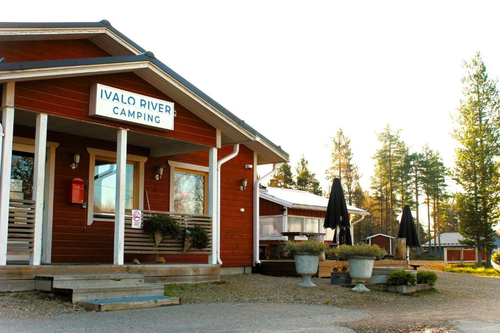 a building with a sign that reads mad river camping at Ivalo River Camping in Ivalo