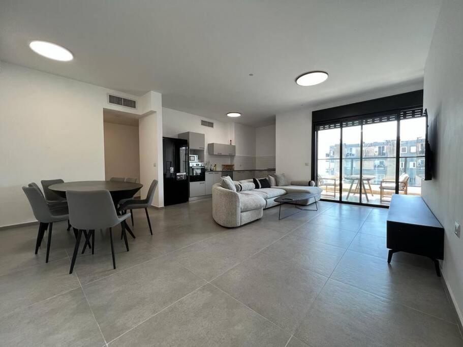a large living room with a table and a couch at Menahem Arber 5 Bedrooms in Tel Aviv