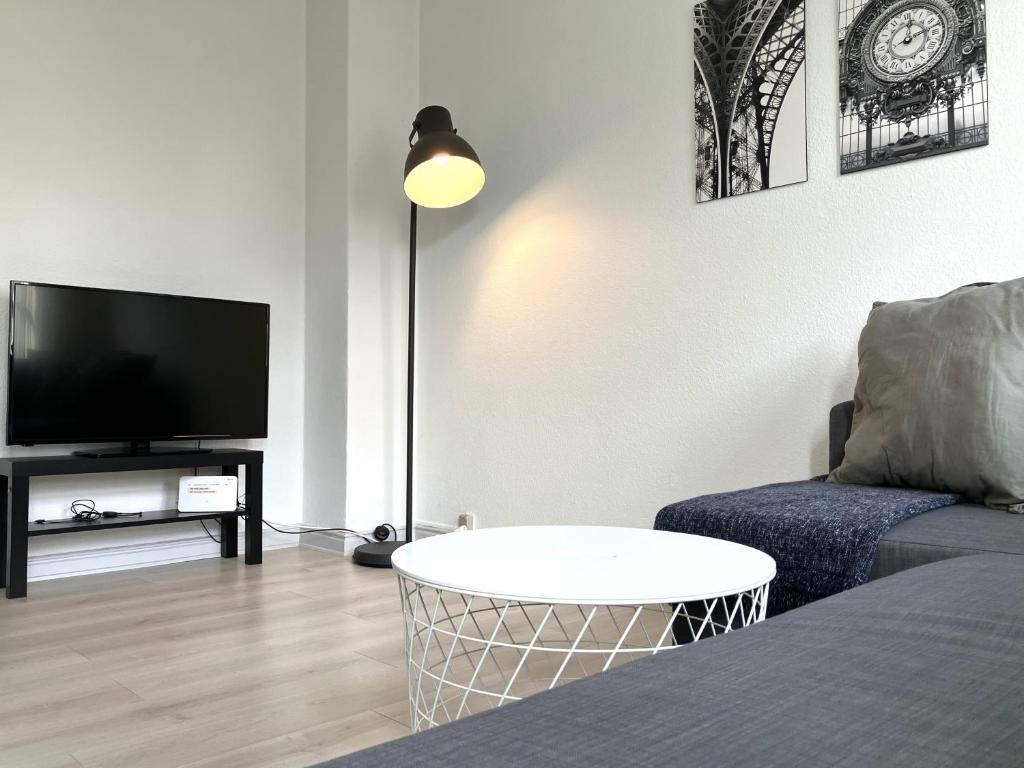 a living room with a couch and a flat screen tv at Three Bedroom Apartment In Kolding, Udsigten 4, in Kolding