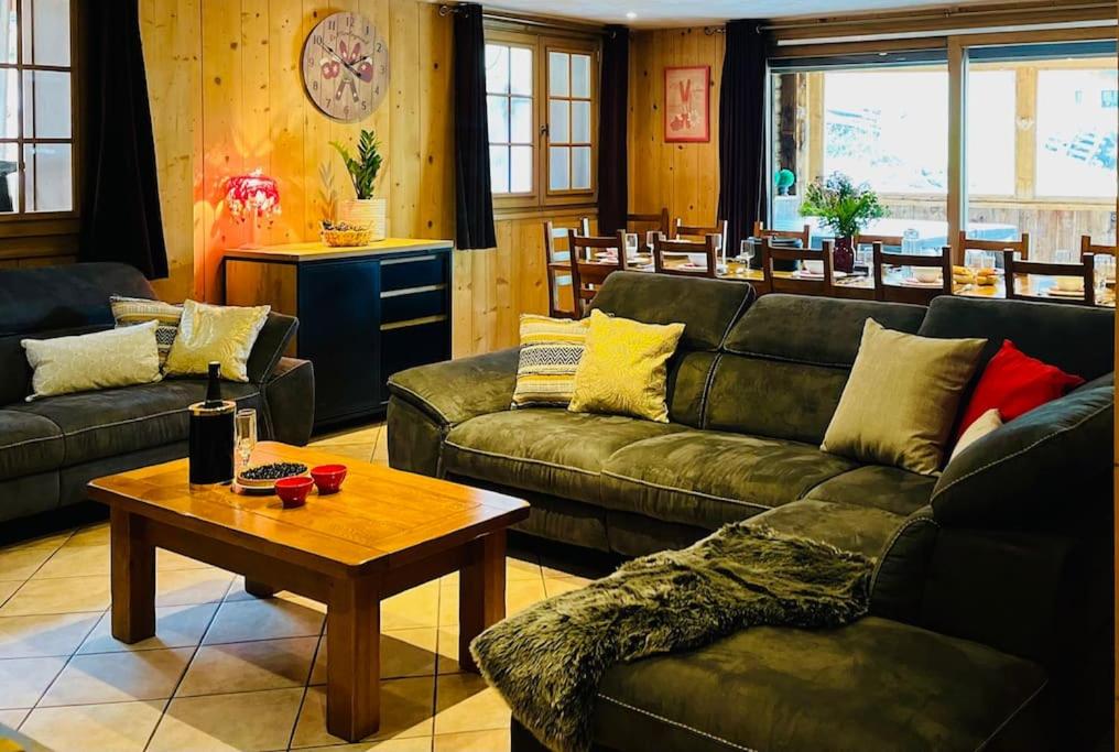 a living room with couches and a coffee table at Chalet Les Lanchettes in Morzine