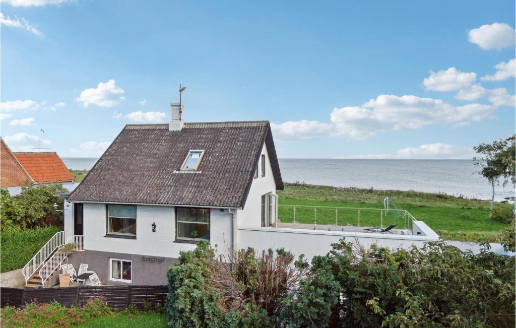 a white house with a view of the ocean at Beautiful Home In Allinge With 3 Bedrooms in Allinge