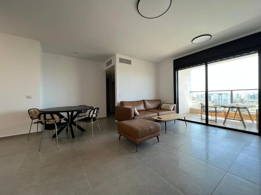 a living room with a couch and a table at Menahem Arber 4 Bedroom in Tel Aviv