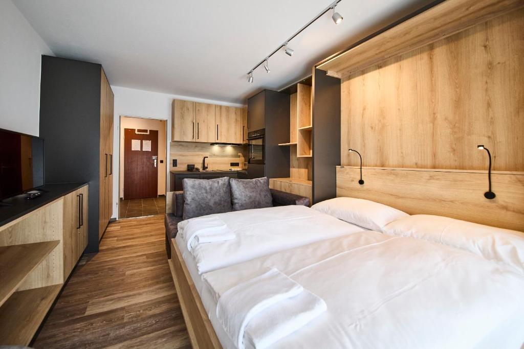 a bedroom with a large bed and a couch at Appartement Bittner in Saalbach-Hinterglemm