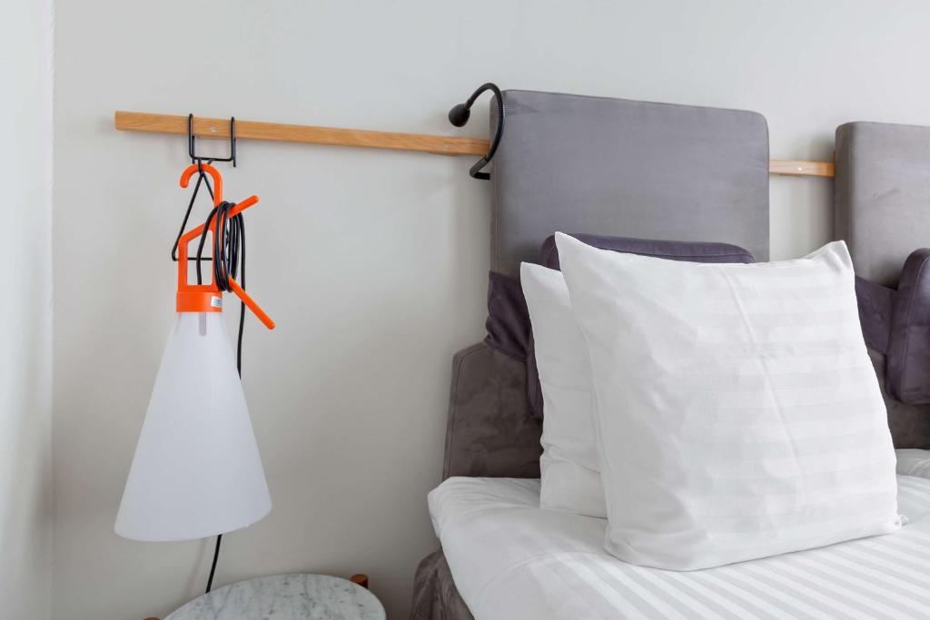 a bedroom with a bed and a white pillow at Best Western Plus Sthlm Bromma in Stockholm