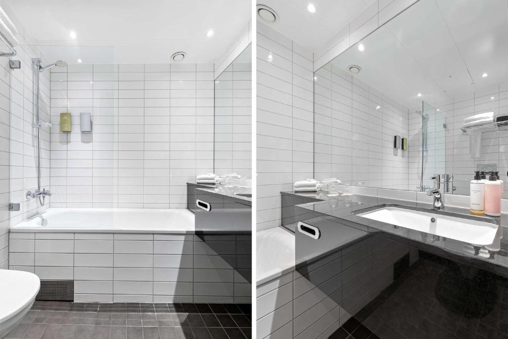 a bathroom with a tub and a sink and a toilet at Best Western Plus Sthlm Bromma in Stockholm