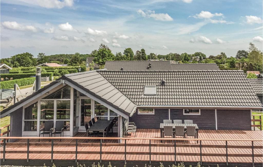 ボーゲンセにあるStunning Home In Bogense With 4 Bedrooms, Sauna And Wifiの屋根付きの大きなデッキのある家
