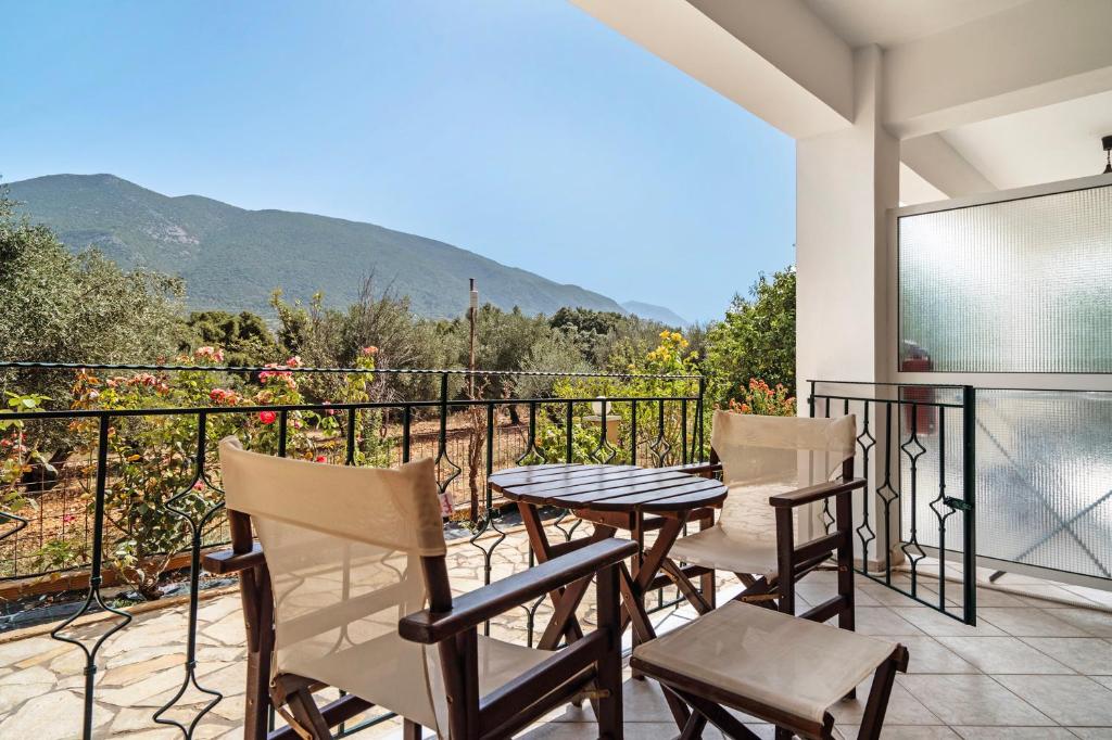 a patio with a table and chairs on a balcony at Daratos studio 5 in Kefallonia