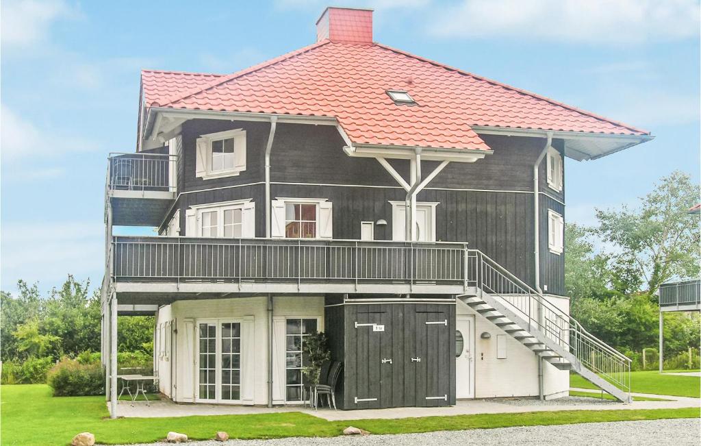 una casa grande con techo rojo encima en Lovely Apartment In Bogense With Sauna, en Bogense